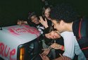 Inspecting graffiti that was sprayed-painted onto the Icarus Line's Van outside of Chain Reaction, Anaheim , Calif, USA.