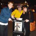 Brett, Nardwuar, Kate Nash outside of Gorilla Food looking at Kate Nash on the cover of the Georgia Straight.
