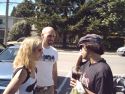 Nardwuar with giant Tomahawk Coke, admiring Heather Peavy-Leone's New York City customizing of her Smugglers t-shirt, as her husband looks on.