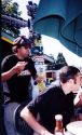 Nardwuar splattering hot Tomahawk jizz on the wincing neck of Smugglers drummer Graham Watson, as Nardwuar stuffed the last crumbs'n'sauce from his Skookumchief hamburger into his mouth. Seconds after this photo was taken, Nard ran into the bathroom and ...washed his hands!